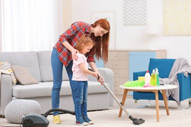 Elektrik süpürgesi kullanan küçük kız
