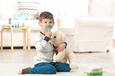 little boy using nebulizer clipart