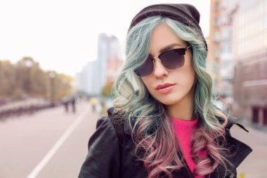 Trendy ideas.Young woman with mint color accent in hairstyle outdoor  clipart