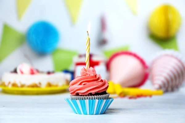 Delicious cupcake with lighted candle — Stock Photo, Image