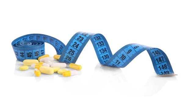 Measuring tape and pills — Stock Photo, Image