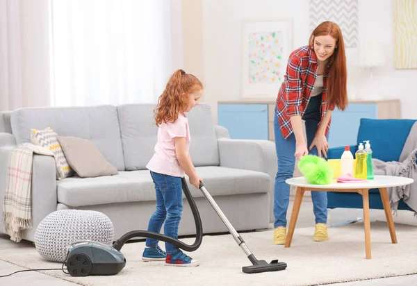 Little girl using vacuum cleaner — Stock Photo, Image