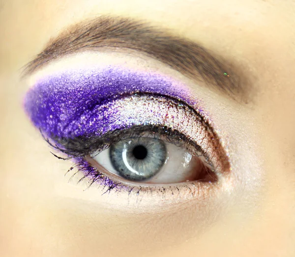 Female eye with lilac makeup