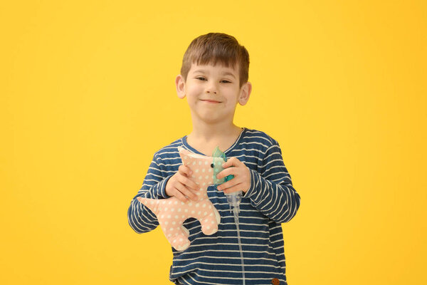 little boy holding nebulizer
