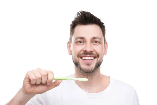 Handsome young man brushing teeth — Stock Photo, Image
