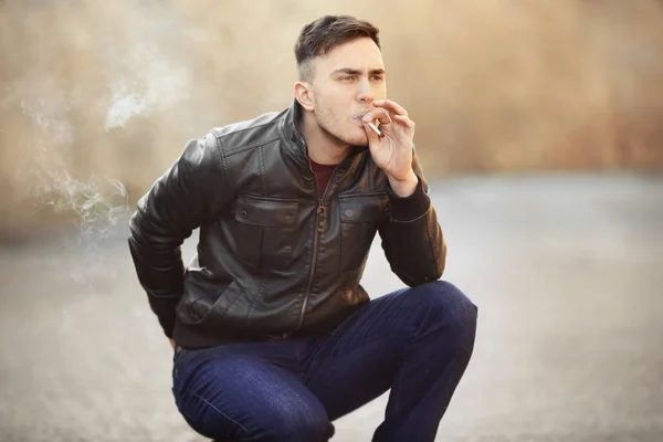 man smoking weed outdoors