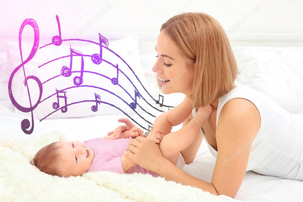 Mother with baby on bed. Lullaby songs and music concept