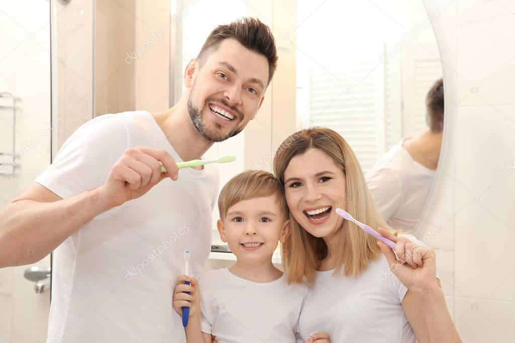 couple and son brushing teeth 