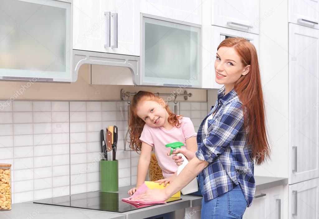 Little girl and her mother cleaning