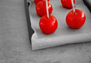 Şeker elma tepsi pişirme üzerinde sopa ile