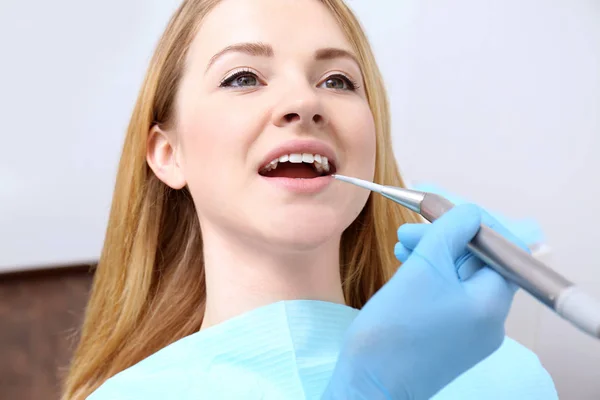 Dentist examining patient's teeth in clinic — Stock Photo, Image