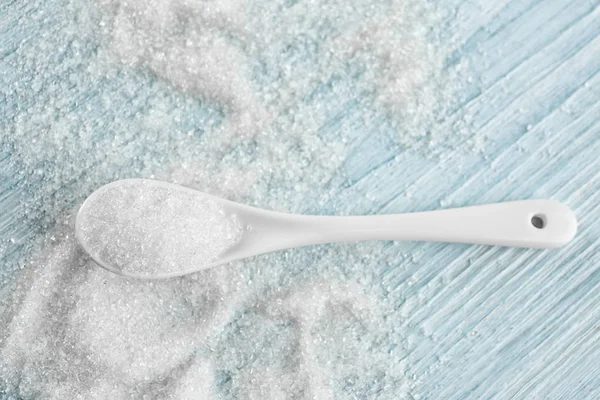 Spoon with sugar on table — Stock Photo, Image