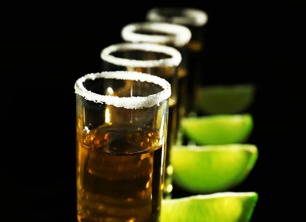 Row of golden tequila shots