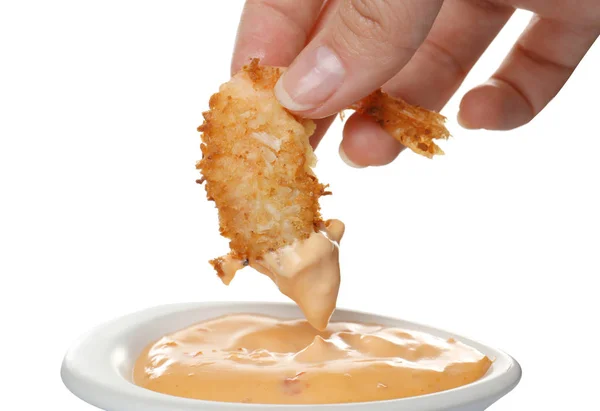 Hand dipping  coconut shrimp in sauce — Stock Photo, Image