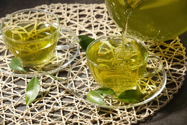 Pouring green tea into glass cup — Stock Photo, Image