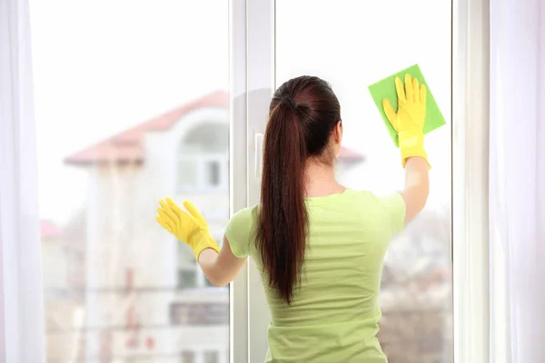 Vrouw schoonmaken venster — Stockfoto