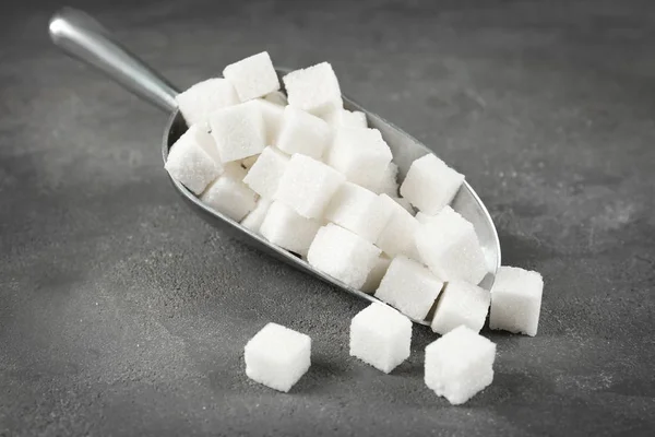 Metal scoop with sugar cubes — Stock Photo, Image