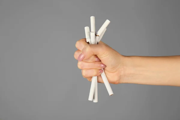 Hand holding heap of cigarettes — Stock Photo, Image