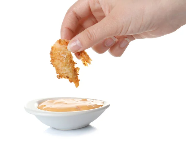 Hand dipping  coconut shrimp in sauce — Stock Photo, Image