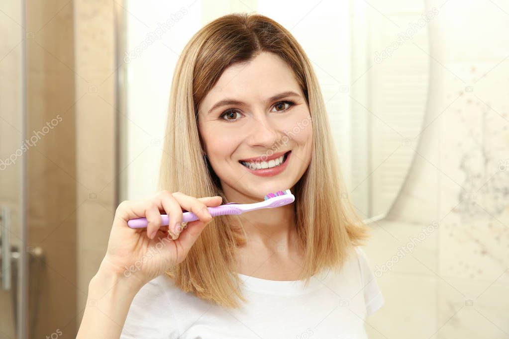 young woman brushing teeth