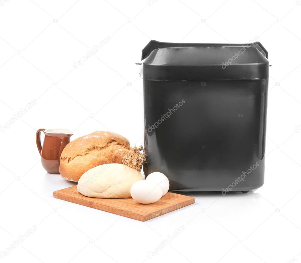 Bread machine, fresh loaf and ingredients for cooking 