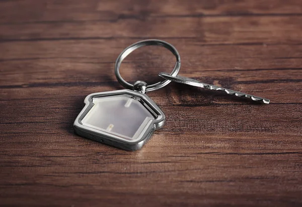 Key on wooden background — Stock Photo, Image
