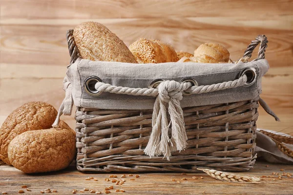 Хлеб с кунжутом в корзине на деревянном фоне — стоковое фото