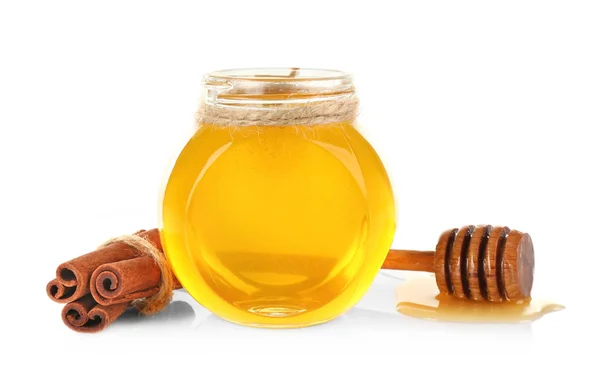 Cinnamon sticks and honey in jar — Stock Photo, Image