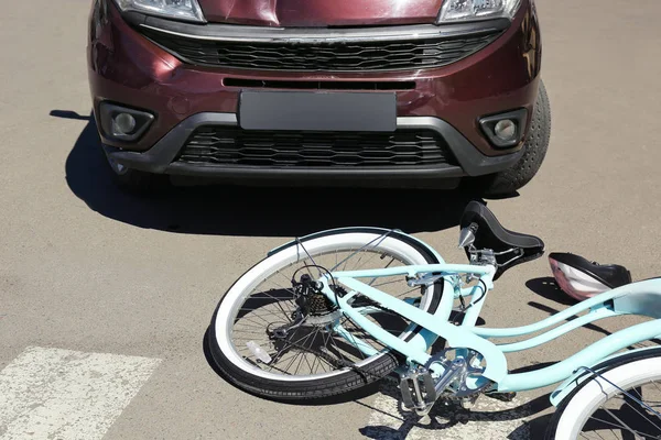 Car and bicycle accident on road