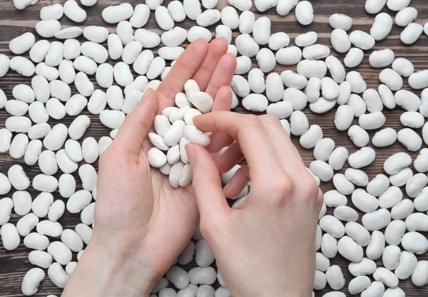 Female hands with butter beans