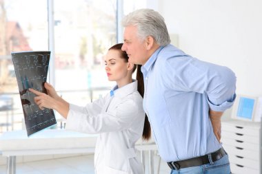 orthopedist examining senior man clipart