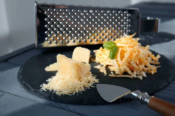 Slate plate with grated cheese — Stock Photo, Image