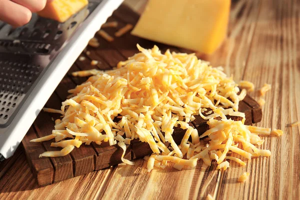 Woman grating cheese — Stock Photo, Image