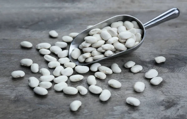 Metal scoop with beans — Stock Photo, Image