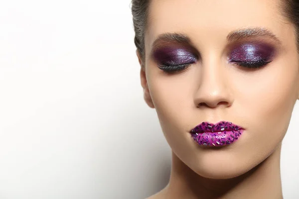 Beautiful young woman with creative makeup — Stock Photo, Image