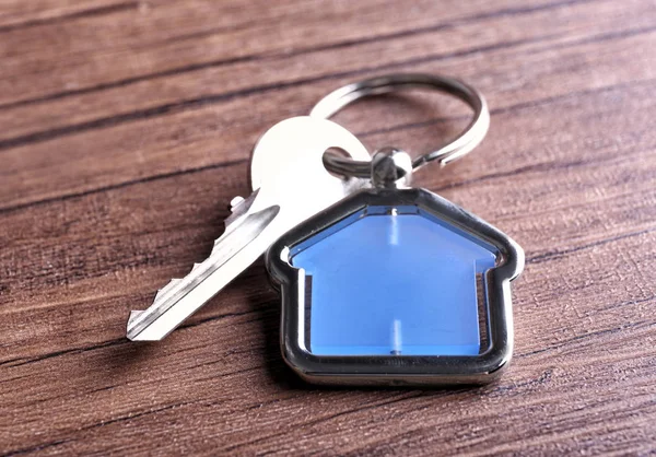 Key on wooden background — Stock Photo, Image