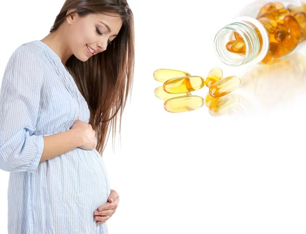 Pregnant woman and capsules — Stock Photo, Image