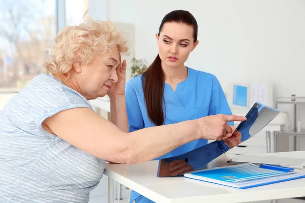 Orthopedist examining senior woman — Stock Photo, Image