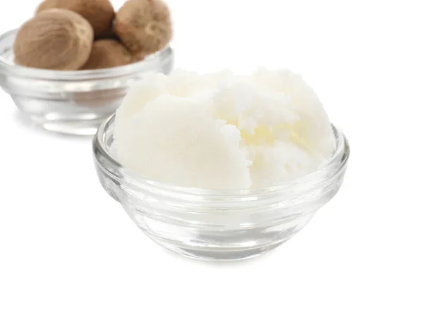 Shea butter and nuts in bowls — Stock Photo, Image