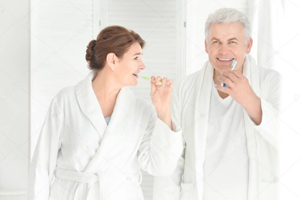 Senior couple cleaning teeth