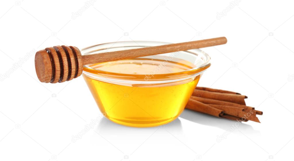 Cinnamon sticks and honey in glass bowl
