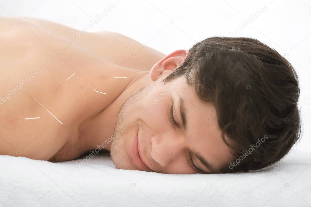 man undergoing acupuncture treatment