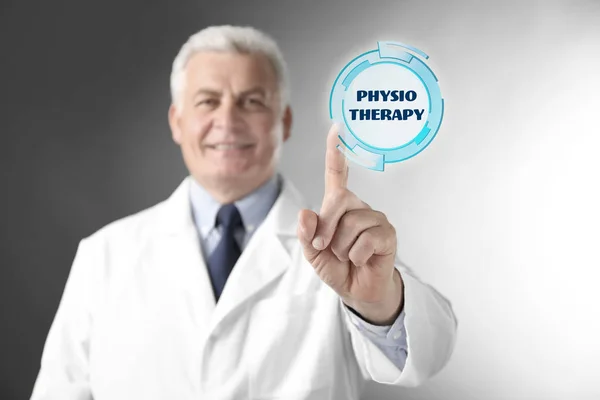 Doctor pointing on word PHYSIOTHERAPY — Stock Photo, Image