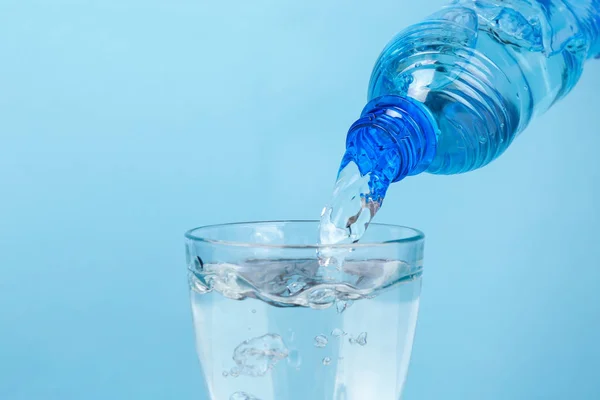 Water pouring from plastic bottle