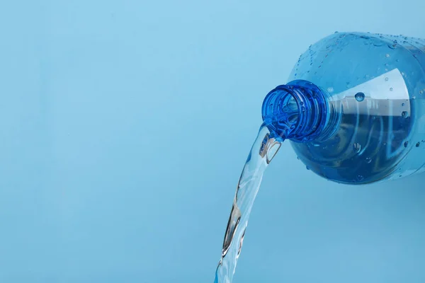 Water pouring from plastic bottle