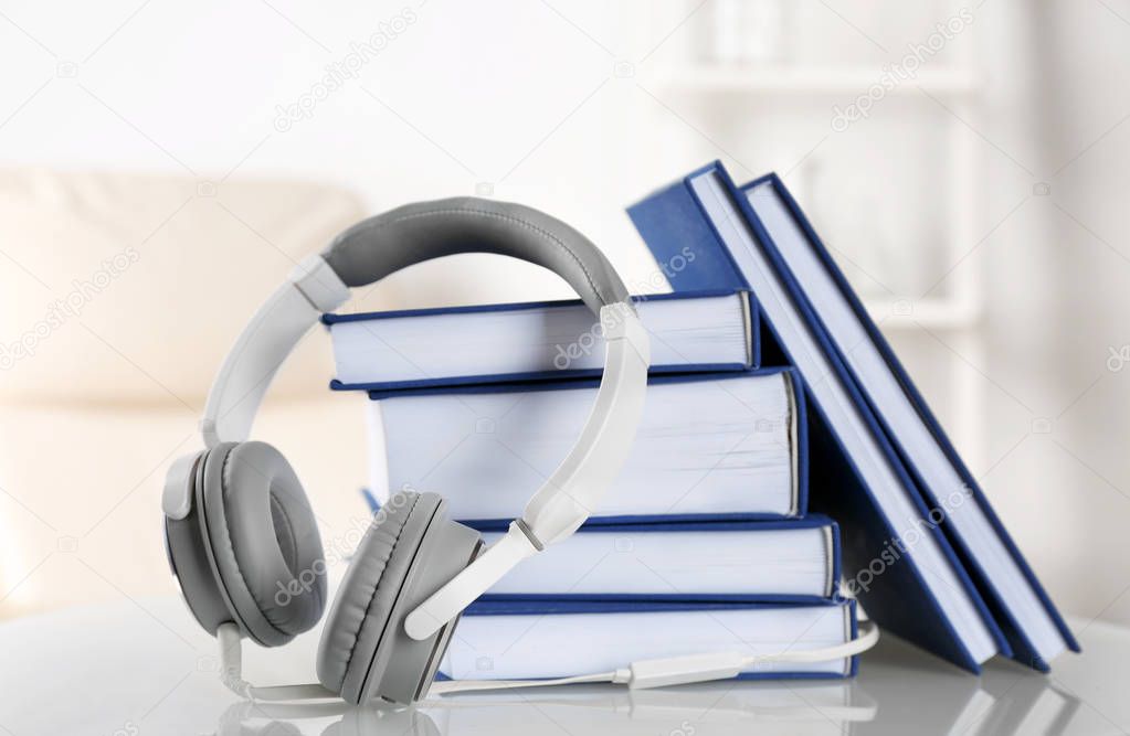 Headphones and books on table.
