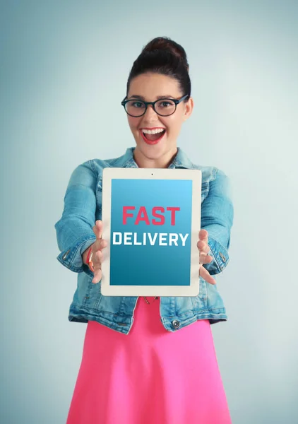 Delivery concept. Young woman holding tablet on color background — Stock Photo, Image