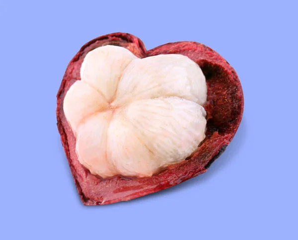 Heart shaped mangosteen on color background — Stock Photo, Image