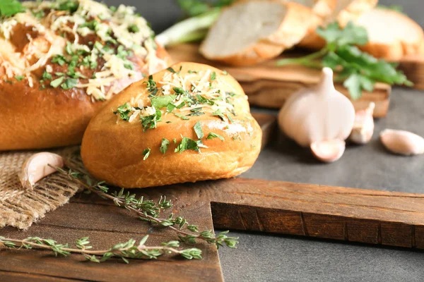 Tasty bun with grated cheese — Stock Photo, Image
