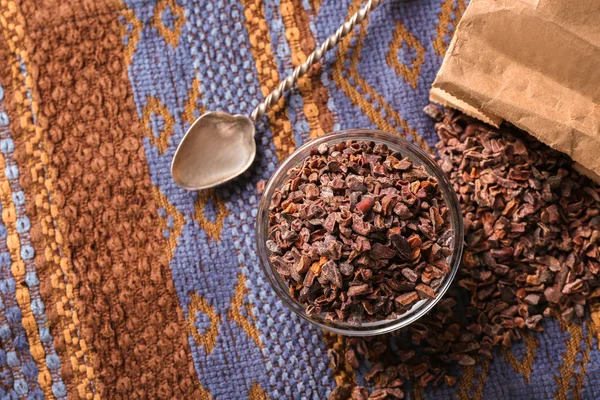 Glass bowl with cocoa nibs — Stock Photo, Image
